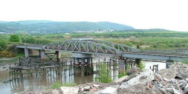 Neath Abbey Swing Bridge The Rhondda and Swansea Bay Railway Company opened its line in 1885, but could extend the line into Swansea until this swing bridge was completed in 1894. I am grateful to the owner of Derwent Construction and his plant operator Martin for their assistance in getting this image. This is one of over 1,450 movable bridges in the British Isles that I have identified for my historical website. www.movablebridges.org.uk