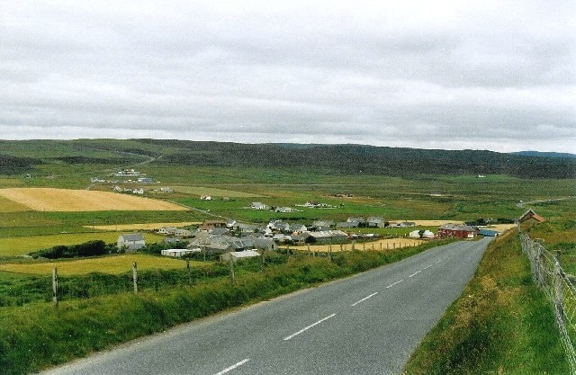 Veensgarth and Tingwall airport. Viewed from the side of Herrislee Hill, looking north. The airport runway is just visible as a line stretching across the middle of the picture from the cluster of buildings in the distance.