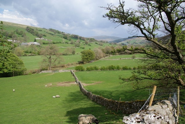 Fields next to the River Dee The valley bottom is flat and fertile.