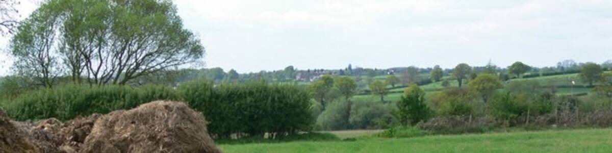Photo "Farmland north of Deeping Lane" by Mat Fascione (Creative Commons Attribution-Share Alike 2.0) / Cropped from original