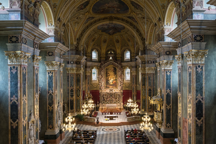 Interior of Brixen Cathedral, South Tyrol. The parish is gathered for Sunday worship.