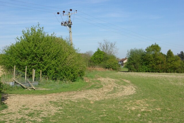 Footpath towards Townland Green The power pole is leaning over rather more than most, probably a bit more than the photograph suggests.