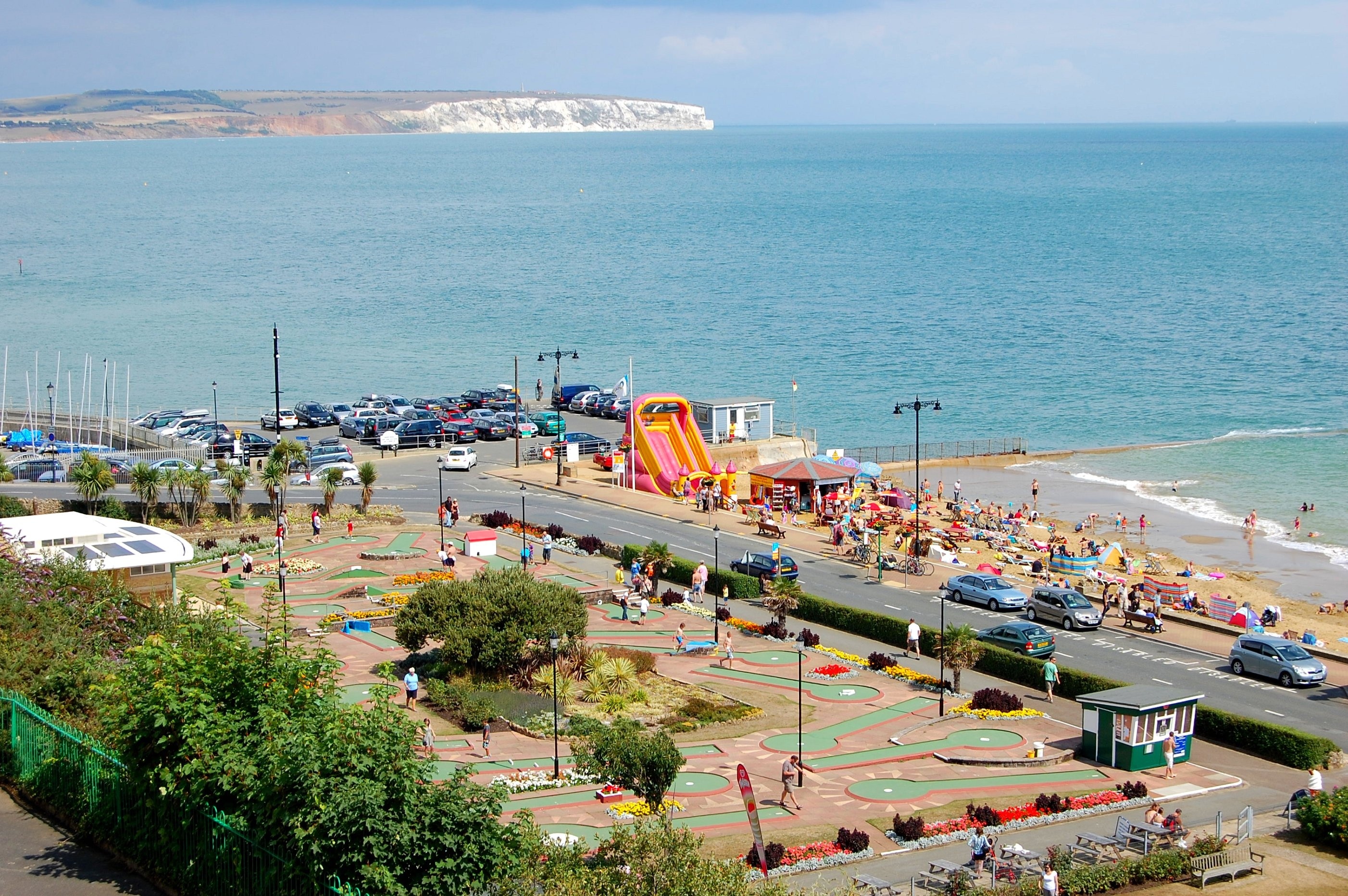 Taken in one of the traditional seaside resorts on the Isle of Wight. UK. Shanklin is a popular seaside resort and civil parish[1] on the Isle of Wight, England, located on the east coast's Sandown Bay. The sandy beach, its Old Village and a wooded ravine, Shanklin Chine, are its main attractions. The esplanade along the beach is occupied by hotels and restaurants for the most part, and is one of the most tourist-oriented parts of the town. The other is the Old Village, at the top of Shanklin Chine. Beaches & Esplanade Shanklin has two beaches; 'Small Hope Beach' and 'Hope Beach.' Small Hope Beach eventually meets Sandown Beach and has many beach huts available for hire, and a small cafe. Hope Beach stretches in the opposite direction. Above Hope Beach is the esplanade which boasts some traditional seaside attractions including an amusement arcade, a crazy golf course, and a children's play area, with slides, ball pools, bouncy castles, rigging, swings etc available to be hired for a childs birthday party. There are several seafront hotels, a cliff lift from the seafront to the top of the cliff, a putting course, several cafes and restaurants and pubs, and a large, clean beach. Shanklin used to have a pier, but this was destroyed in the Great Storm of 1987. The pier formerly had a theatre at which many famous performers appeared, including Paul Robeson, Richard Tauber and Arthur Askey (whose daughter attended a local boarding school called Upper Chine School for Girls). The Summerland Amusement Arcade on the seafront was formerly a seaplane hangar positioned at Bembridge where it housed Fairey Campania seaplanes of the Nizam of Hyderabad's Squadron. Much of the seafront was cleared in World War Two bombing. Shanklin Sailing Club is situated at the North end of the Esplanade. Founded in 1931 as 'Shanklin Amateur Sailing Club', the club has a fleet of Sprint 15 catamarans and holds races three days a week during the season.[6] Further along the beach is the Fisherman's Cottage pub. This is at the bottom of Shanklin Chine[7], from which the town takes its name, historically "Chynklyng Chine" and in the Domesday Book of 1086 Sencliz (held by William FitzAzor; Jocelyn FitzAzor) from "Scen-hlinc" [8][9]. The Chine is open to the public for a small fee and continues up to Rylstone Gardens in the Old Village. It contains a small section of the pipe of the "Operation Pluto" pipeline which ran across the Isle of Wight and out from Shanklin and another branch from Sandown to supply fuel to the D-Day beaches