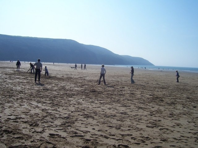 North Devon : Cricket on the Beach Some people play cricket on the beach. Behind them is Baggy Point.