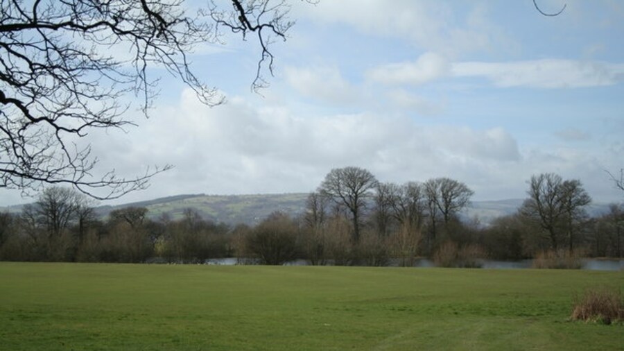 Photo "Distant Hills This view to the Welsh Mountains takes in the lake at Wynnstay Hall, but sadly fishing not allowed." by Geoff Evans (Creative Commons Attribution-Share Alike 2.0) / Cropped from original
