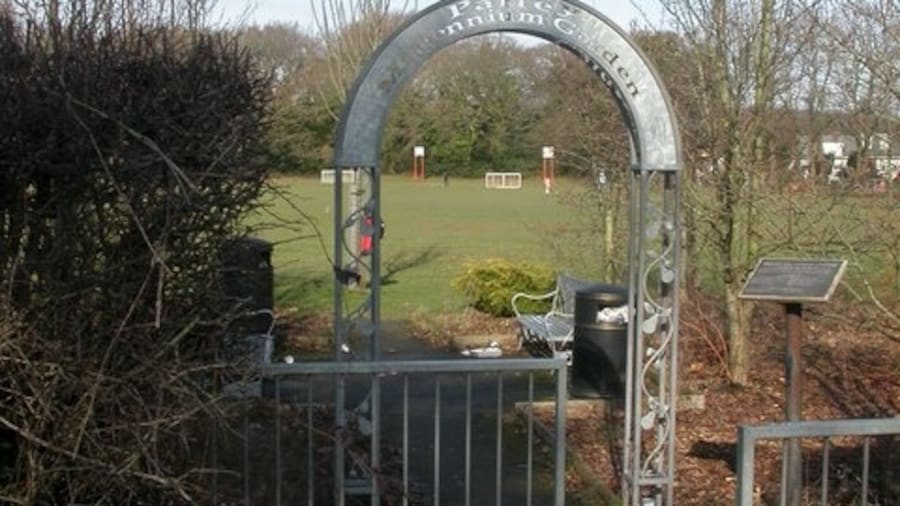 Photo "Parley Millennium Garden, arch. Smart galvanised entrance arch with floral decoration. Behind the arch, Parley Millennium Garden, owned by West Parley Parish Council. Note also galvanised benches behind the arch, and behind the trees to the right, Parley Sports Club 1171464." by Mike Faherty (Creative Commons Attribution-Share Alike 2.0) / Cropped from original