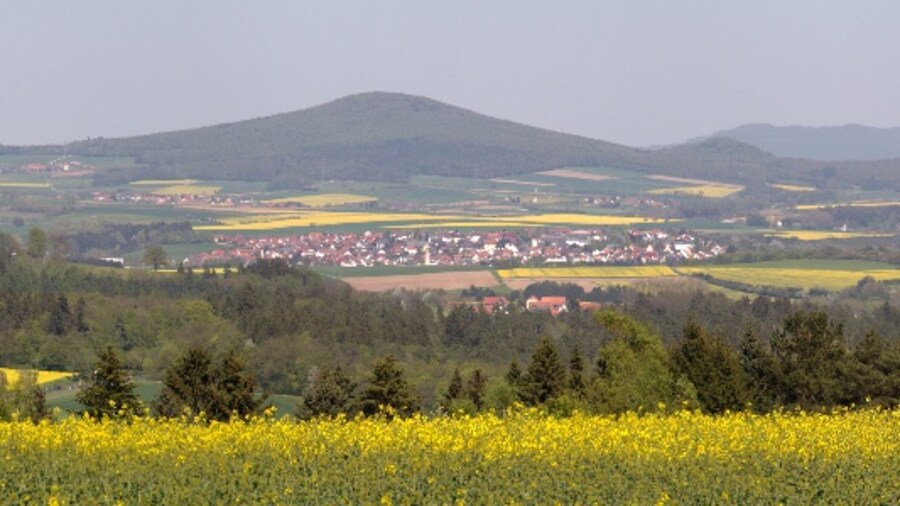 Photo "Panoramic view of Hessisches Kegelspiel (Hessian Skittles - Rhoen Mountains) (LPA:378477, Hessische Rhön), Oberfeld Huenfeld (HWO2 Hiking Trail), Hesse, Germany" by UuMUfQ (Creative Commons Attribution-Share Alike 3.0) / Cropped from original
