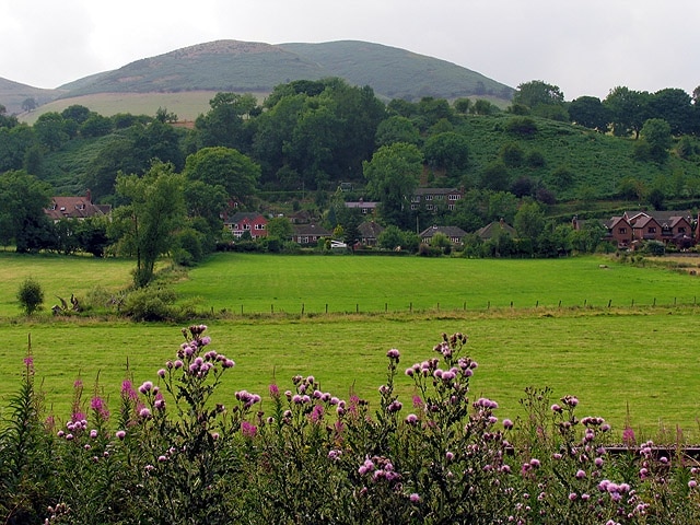 Farmland near Little Stretton. This view of fields between the railway line and Little Stretton is in the southern half of the square. The square is characterised by farmland and residences in Little Stretton. It also contains the site of an old castle, not visible in this picture.