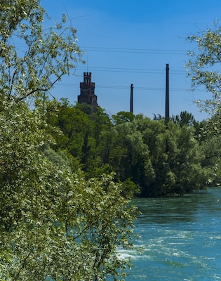Smokestacks of former textile mill at Crespi d'Adda seen from near footbridge on the Trezzo side of the river.