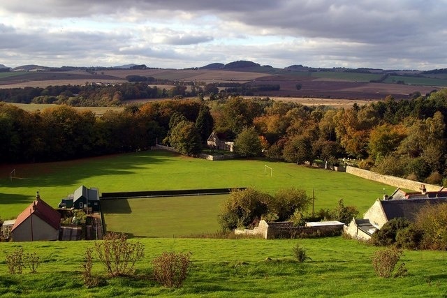 Kemback, bowling green and playing field Looking west over Kemback village towards Cupar