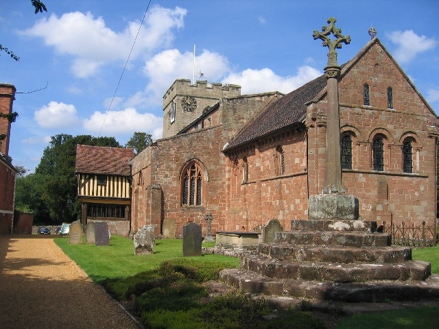 The Church of St John the Baptist, Berkswell. This picturesque church has many interesting features including the unusual timber framed porch and the tower with both a sundial and clock.