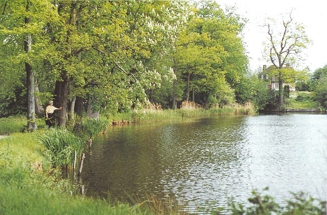 Furnace Pond: Horsmonden's 17th century iron foundry The north-east end of Furnace Pond. The head of water from this 16 acre lake once powered the giant hammer of John Browne's forge, the flames of which could be "seen about the country at 10 miles distance". With the abundance of iron ore in the local clay and of wood to fuel the blast furnace, Horsmonden in 1613 had 200 men employed in its iron foundry under John Browne. Such was Browne's skill in casting and proving guns that he was later granted a monopoly as "Gunfounder for the King's Service". In 1638 Charles I himself was here to watch a gun being cast. Browne also supplied guns to the Dutch, at that time the greatest sea power. Then, on the arrival of Cromwell and the Commonwealth, he was quick to switch his allegiance and was casting guns for Parliament until his death in 1651. When this former King's Gunfounder was buried, an impressive alabaster and black marble monument was erected to him in Horsmonden parish church 917323. But it stands there no longer. A 19th century Rector, an ardent Royalist, could not abide to see a memorial in his church to a man who had turned his coat for Cromwell, and removed it! See other snippets from the surprising history of Horsmonden at: https://books.google.co.uk/books?id=2_ZstVBZSfIC&lpg=PA1&pg=PA99#v=onepage&q=&f=true There is little now to show for this once great industry apart from such local names as Flightshot Farm TQ6840, Furnace Pond, and the old Gun Inn, and several chalybeate springs. See also Gallery at: https://www.geograph.org.uk/gallery/the_history_of_horsmonden_8738