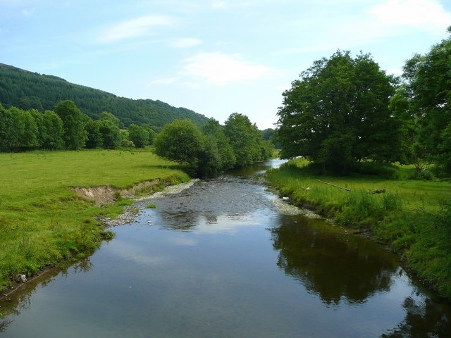 River Teme - summer View downstream from Stowe Bridge. Tornett Wood is on the steep valley side to the left in Shropshire.