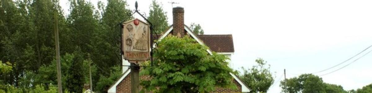 Photo "Twinstead village sign, Essex. This sign actually stands at Twinstead Green." by Robert Edwards (Creative Commons Attribution-Share Alike 2.0) / Cropped from original