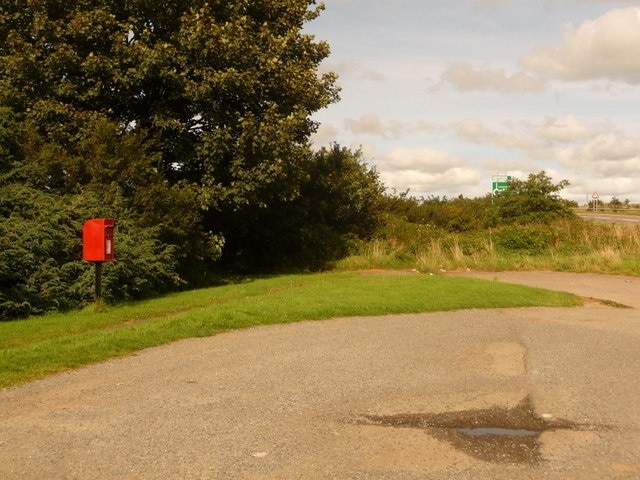 Kennards House: postbox № PL15 31 A small postbox on the old course of the main road, dating before the main dual carriageway was put through: at the extreme right-hand edge of the picture, a redundant cat's eye can be discerned, now occupying a curiously non-central position in a little driveway. The postbox is emptied at 10:30 each morning except Sunday.