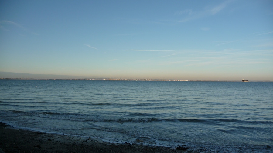 Portsmouth city centre, seen across the Solent from Seaview Duver (Duver Road), Isle of Wight. Visible are the Spinnaker Tower and Number One Tower.