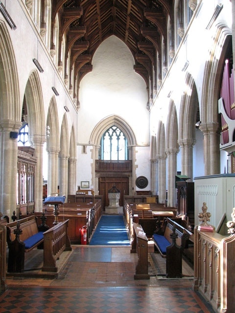 The church of SS Peter and Paul - view west. The church of SS Peter and Paul > 1702998 was built in the 15th century on the site of an older church. It has a magnificent hammerbeam roof which rises to a height of 45 feet above the floor. The building contains many other medieval survivals such as the panels of the chancel screen > 1703026 - an older screen surrounding the Lady Chapel with intricate carvings in its spandrels > 1703031 - choir stalls in the chancel > 1703049 - remains of a mural and the octagonal font > 1703053. There are also a number of interesting tombs. To members of the Lovell family on either side of the east window. To Anne, only child of Sir Robert Herling, on the north wall of the chancel > https://www.geograph.org.uk/photo/1703037. To Sir Robert Herling (d 1435) at the east end of the south aisle > https://www.geograph.org.uk/photo/1703041. To Sir Thomas Lovell and Dame Alice, his wife, with their crests (a bundle of peacock feathers and a Saracen's head) at their feet > https://www.geograph.org.uk/photo/1703043. The most noteworthy feature of the church, however, is the magnificent east window > https://www.geograph.org.uk/photo/1703014 which was donated to the church by Lady Anne Herling and her second husband, Sir Robert Wingfield, in around 1460. Removed for safety in Cromwell's time, the glass of this notable window was hidden in the attic of the since demolished East Harling Hall. When the manor was sold to Thomas Wright in 1736 he restored the glass to the church. It was removed once again during WWII and replaced and re-leaded in 1947.