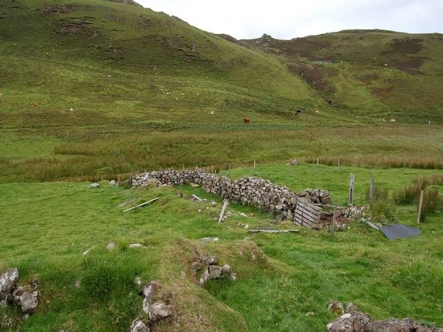 Sheepfold at Oisgill. Judging from the pallet and recent fencing, this is still in use. The sheepfold is surrounded by ruins, suggesting it was once part of a settlement in this now uninhabited glen.