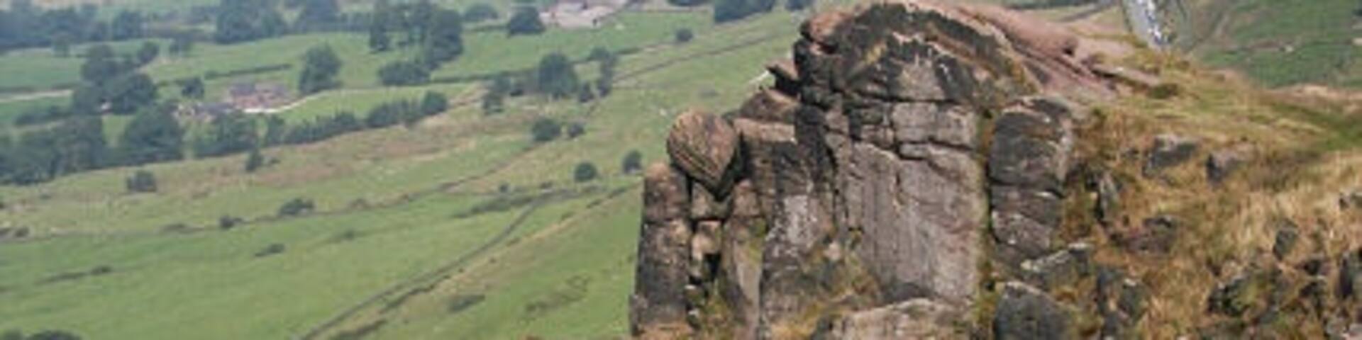 Rock climbing on The Roaches A couple of climbers can be seen on the steep climb from Five Clouds.
