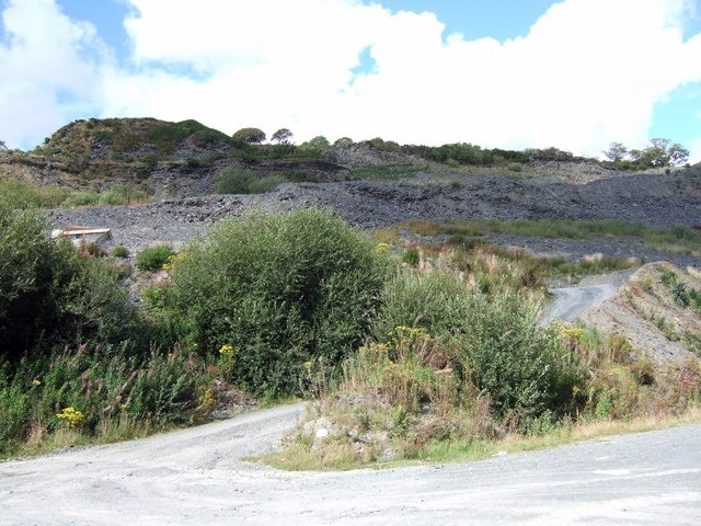 Old slate quarry at Glogue Slate extraction probably started here in a small way at the end of the C18 but output only picked up in the 1820s and 30s. It grew substantially during the second half of the C19, peaking in 1873 when 80 men were employed, producing 2000 tons of slate a year. It was also in 1873 that the railway finally opened, with the purpose of easing the transport out. Production slowed down in the C20 and the quarry was worked by a local syndicate until it closed in 1926.