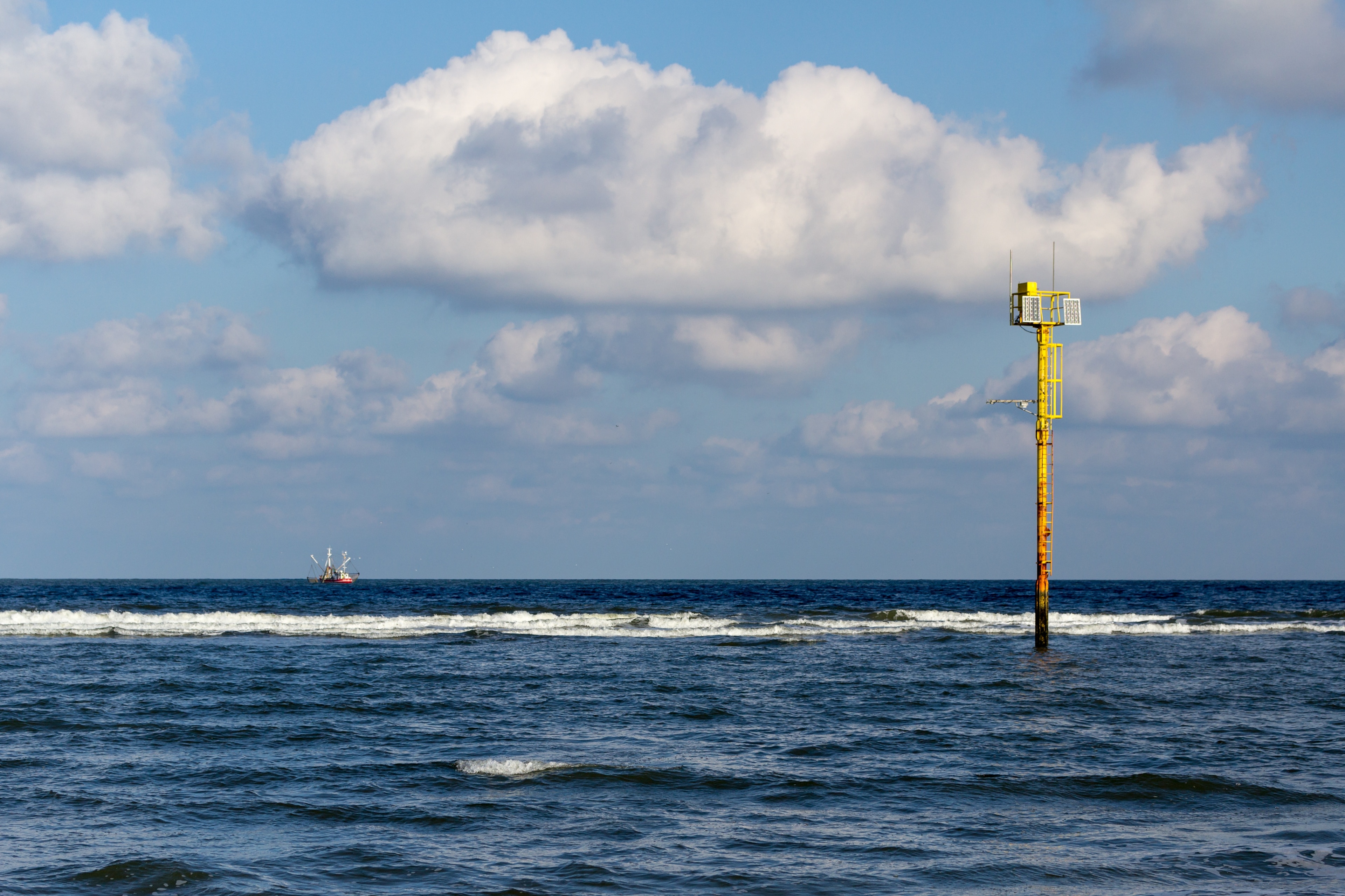 Yellow special purpose buoy “Mess-G” at North Sea at the eastern beach in Norderney, Lower Saxony, Germany