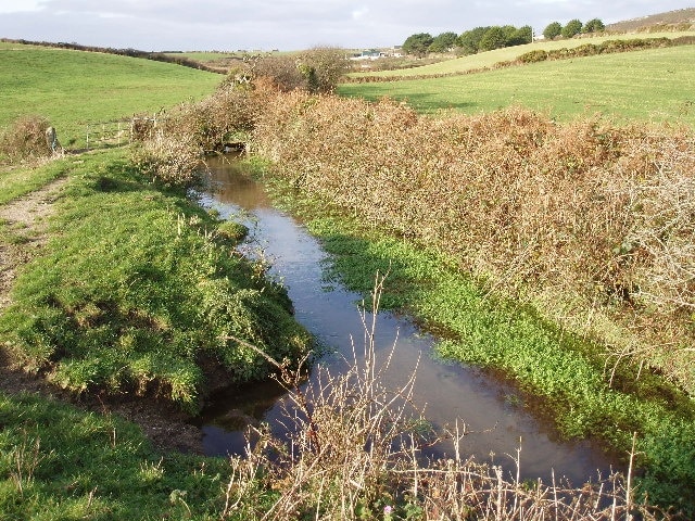 Stream in fields between Treave and Rissick. Looking north west. Still largely cattle farming in the small hamlets around St Buryan. Camp site and pottery at Treave in the distance.