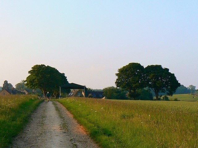 An evening view north, near Lower End, Gloucestershire The buildings in this view mark the southern extent of the village of Lower End. The bridleway, in good condition, is gated at its entrance a little way further on from here.