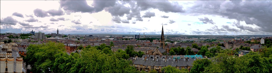 This panorama was stitched together from photographs taken on the 21st of July 2015 at about 10 am in the morning. It shows Glasgow University on the far left with the university tower and the library in view. To the right of the university tower part of the Western Infirmary can be seen. This photograph also covers the area south of the River Clyde. The extreme far right of the panorama shows the new Southern General Hospital but it is only visible upon zooming into the photo. This was taken on the rooftop of 6 Crown Terrace.