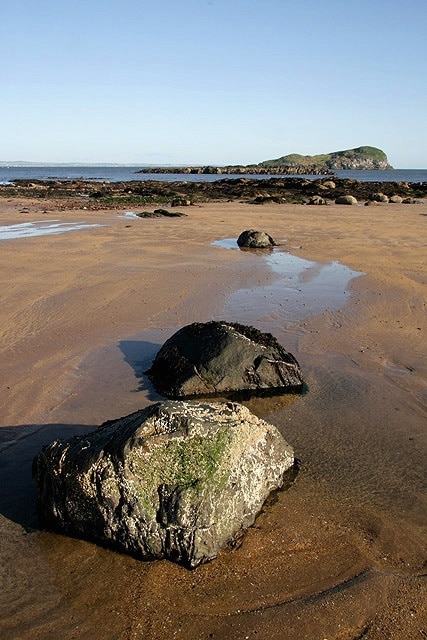 Rocks on the beach at North Berwick The island in the background is Craigleith.