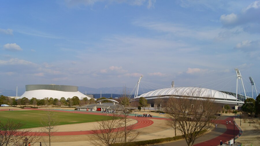 Photo "(right to left) Main stadium aka KKWING, supplemental track, the Park Dome of Kumamoto prefectural sports park, Japan." by Motoki-jj (Creative Commons Attribution-Share Alike 3.0) / Cropped from original