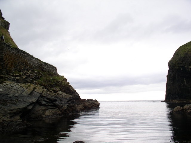 At the foot of the Whaligoe Steps Looking to sea from where the boats would have been hauled up, past the built working area.