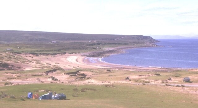 Opinan. The wind has built up and partly destroyed the dunes around this exposed beach.