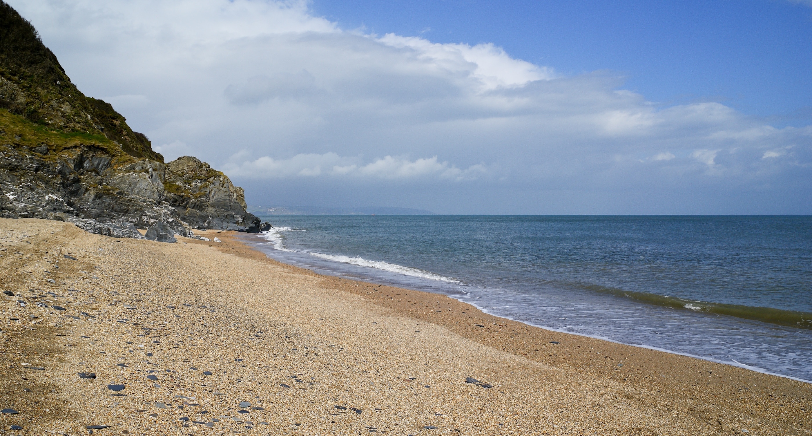 Looking north up Start Bay from Beesands, Devon, UK. It shows the contrasting weather that can be found along the coast with sun at the point of the camera to cloud and rain within 2 kilometres.