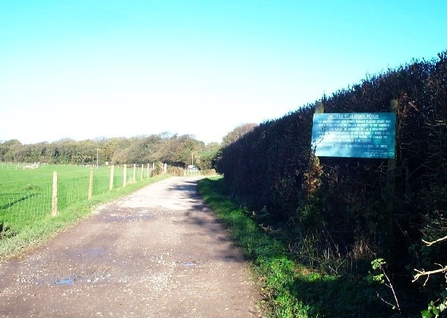 Lane to Lilstock beach. Access to the beach car park is via a private road. The sign details what conditions there are for its use by the general public. The photograph is taking looking north at the junction with the lane to Lilstock.