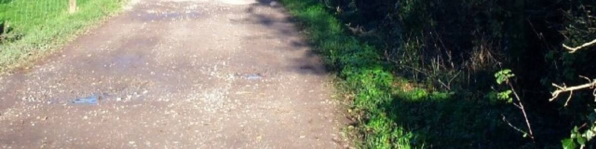 Photo "Lane to Lilstock beach. Access to the beach car park is via a private road. The sign details what conditions there are for its use by the general public. The photograph is taking looking north at the junction with the lane to Lilstock." by Barbara Cook (Creative Commons Attribution-Share Alike 2.0) / Cropped from original