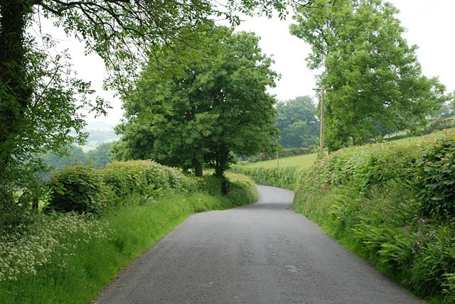 Road north west from Silian Beginning its descent towards its junction with the A482.