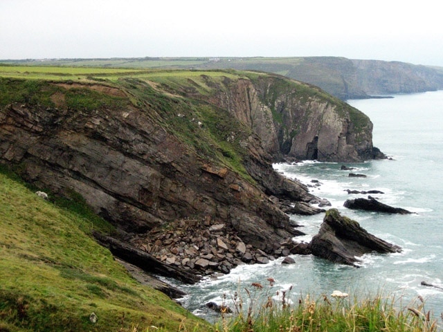 Rugged coastline north of Druidston Haven Natural arches and piles of fallen rock are a feature of this stretch of the Pembrokeshire Coastal Path.