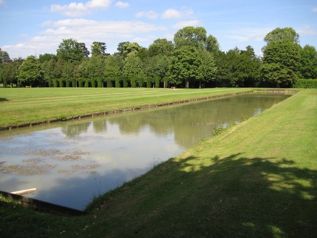 Wrest Park: Leg 'o' Mutton Lake This lake, in the formal landscaped gardens of Wrest Park, used to have a semi-circular extension on its south side which gave it its name. If you look very carefully at the pattern in the grass on the right side of the lake the old shape can just about be made out. This semi-circular section was surrounded by a small grassy amphitheatre. The change has been so recent that the current Ordnance Survey 1:10,000 scale online mapping shows it while the 1:25,000 scale shows the original shape. Beyond the lake is the bowling green with its close-clipped yew arches. From a Geograph point of view the 509000 Easting gridline passes through the lake so the far end is in the TL0935 grid square rather than this one.