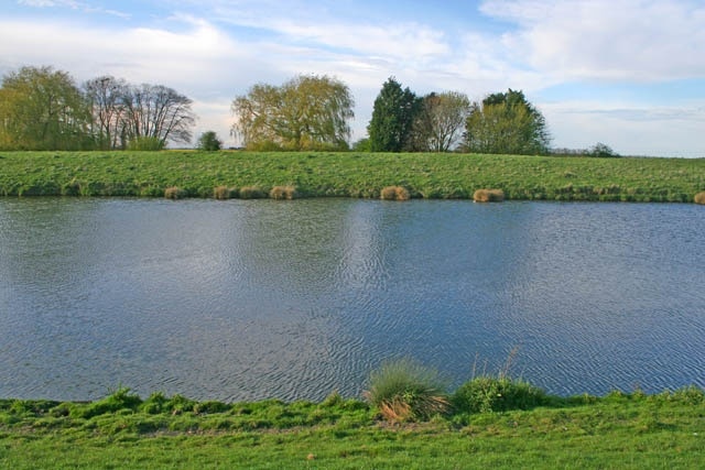 River Witham. Looking across the river from one flood bank to the other The water level in the river is about 2 metres above the surrounding farmland and is controlled by a sluice gate and lock in Boston. See 416479 and 777322. A quiet and pleasant boating route from Lincoln to Boston, there are only 4 locks to negotiate on the 36 mile journey.