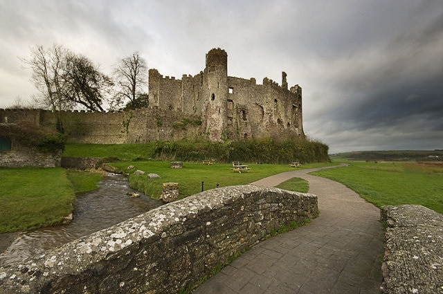 Laugharne Castle Photo taken from footbridge over River Coran