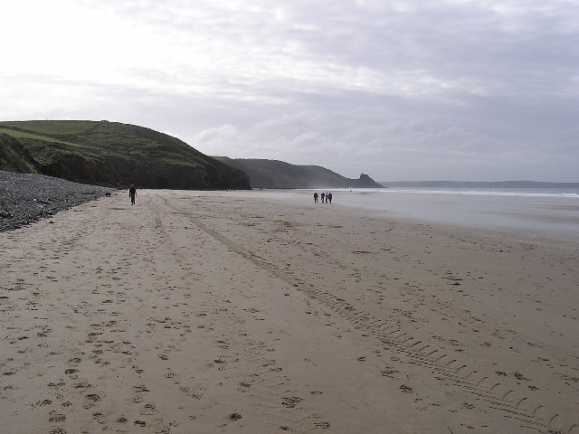 Newgale Sands. Newgale sands is very popular as a surfing beach. In the near distance is Maidenhall Point whilst in the middle distance (centre right) is Rickets Head.
