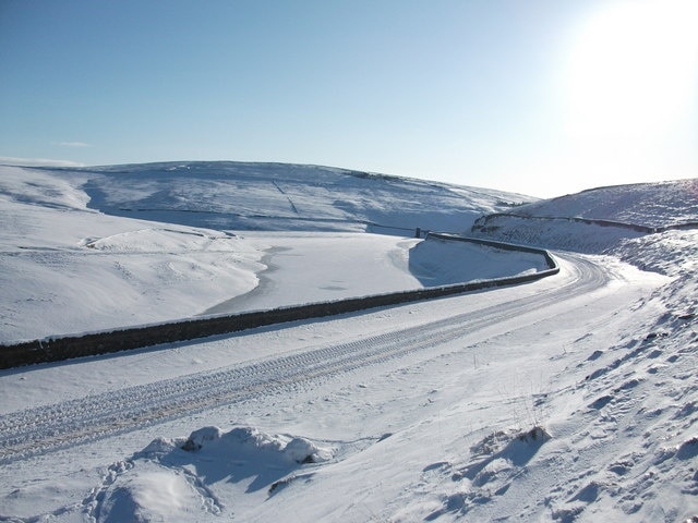 New Years Bridge Reservoir. The road running parallel with the frozen reservoir is the main A640 known locally as "Nont Sarahs" This winters shot was taken after three weeks of constant freezing weather conditions resulting in all the local reservoirs being frozen over solid. Compare this with 505998 taken in the summer of 2007