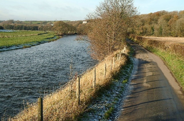 Riverside Road. A beautiful feature of the landscape where the river, road and, at one time, the railway,run alongside of each other. The woods in the background are a sanctuary for red squirrels.