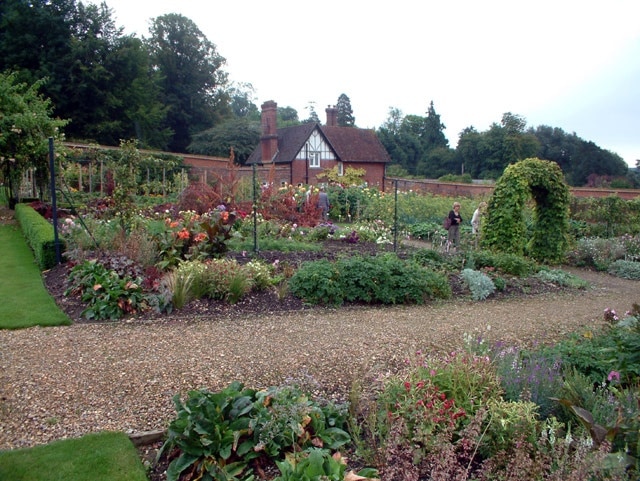 The walled garden at Titsey Place, Limpsfield, Surrey RH8. In 1996, the kitchen garden at Titsey Place was completely restored as an illustration of Victorian horticultural techniques. The garden paths were remade, the glasshouses rebuilt, and the garden planted with a wide range of fruit including pears, apples, cherries, quince and figs. Summer annual flowers are grown amongst a wide range of unusual vegetables.