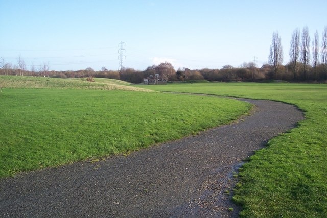 Path in Sturry Road Community Garden This path leads from Tennyson Avenue around the large green area. This area was a landfill tip, turned over to the Sturry Road Community Garden Trust in 2002. The trust then brought in several tons of soil to landscape the flat ground. The area on the right is the 'kickabout area', beyond is the bmx track. Play areas and garden areas are to the left. A ecology park is being developed as well.