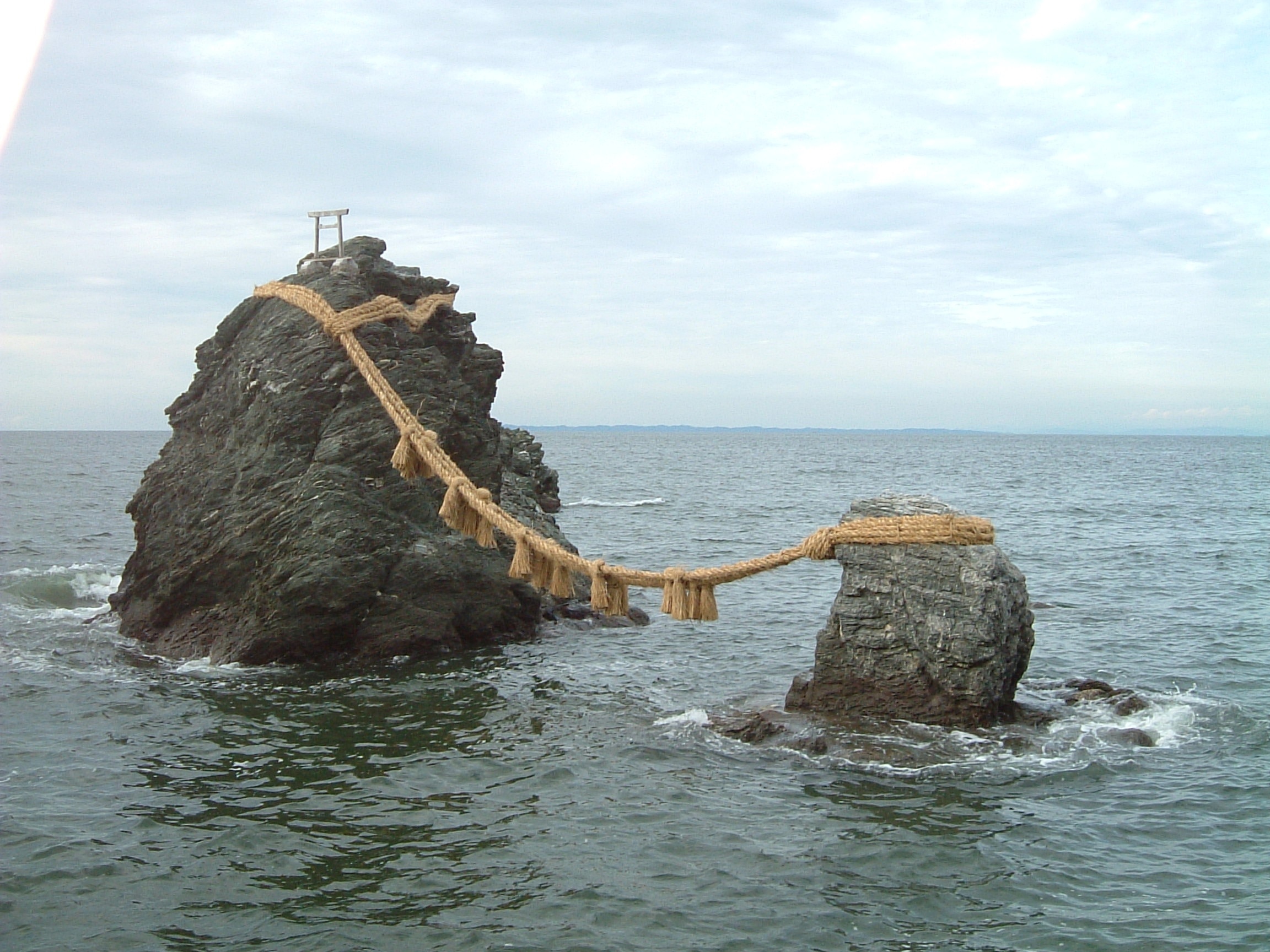 夫婦岩 Meotoiwa in Futami Japan at high tide.