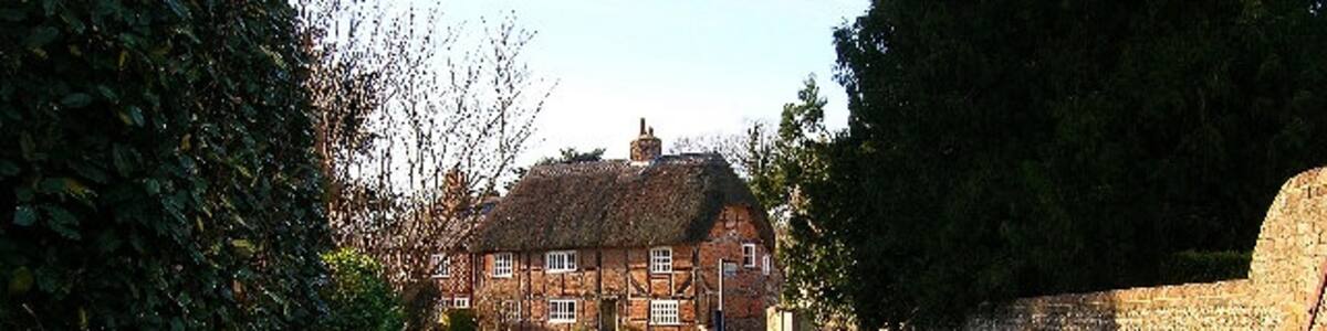 Photo "The Thatched House, West Ashling. What the picture doesn't make clear is the distinct herringbone brickwork. This view looks west from the junction of the B2146 and Down Street." by Simon Carey (Creative Commons Attribution-Share Alike 2.0) / Cropped from original
