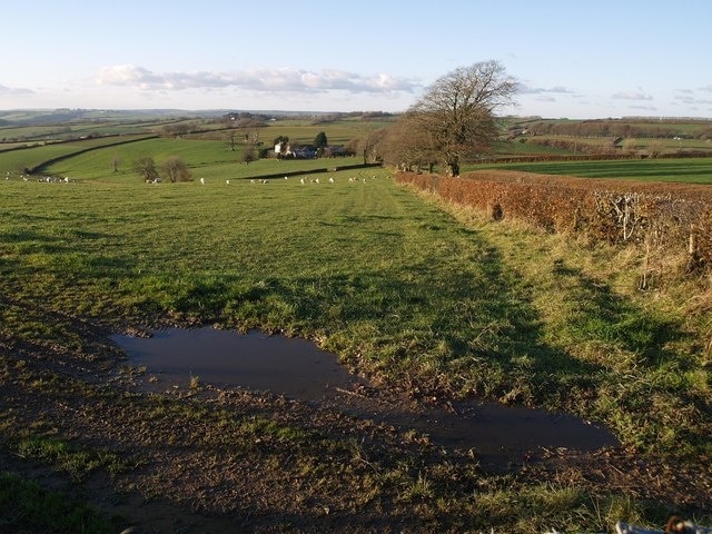 Field beside Yarde Cross The hedge on the right conceals the farm road to Yarde, whose buildings are in SS6434. Yarde Cross is where the farm road meets the road between Stone Cross and Kimbland Cross.