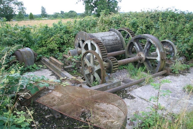 Remains of converted steam winch, Swannington This is at the top of the Swannington Incline and appears to have been relocated here. It was once a double reduction geared twin cylinder steam winch. One disc crank has been replaced by a gear and there is a loose electric motor and chain guard that presumably went with it. The engine has Easton & Tattersall, Leeds cast in the bed - a maker I'm not familiar with.