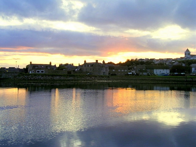 Sunset on the River Lossie at Lossiemouth The church to the right is Saint Geradine's.
